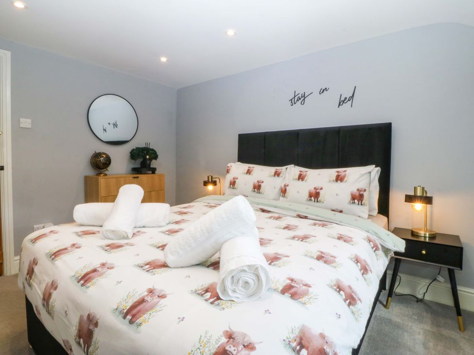 A bedroom with a bed and side table at Old Chapel House in Abergwyngregyn near Llanfairfechan