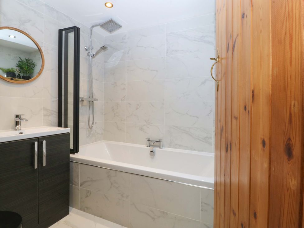 A bathroom with a bathtub and sink at Old Chapel House Abergwyngregyn near Llanfairfechan