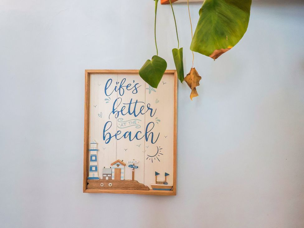 A framed wall art with beach theme at Riverdance Cottage in Lyme Regis