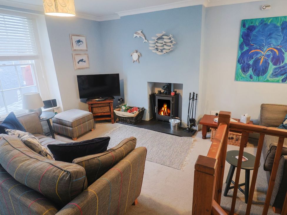 A living room with furniture and fireplace at Riverdance Cottage in Lyme Regis