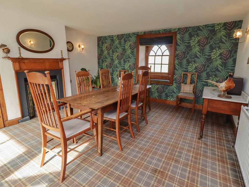 A dining room with a table and chairs at The Coach House in Crookham near Cornhill-On-Tweed
