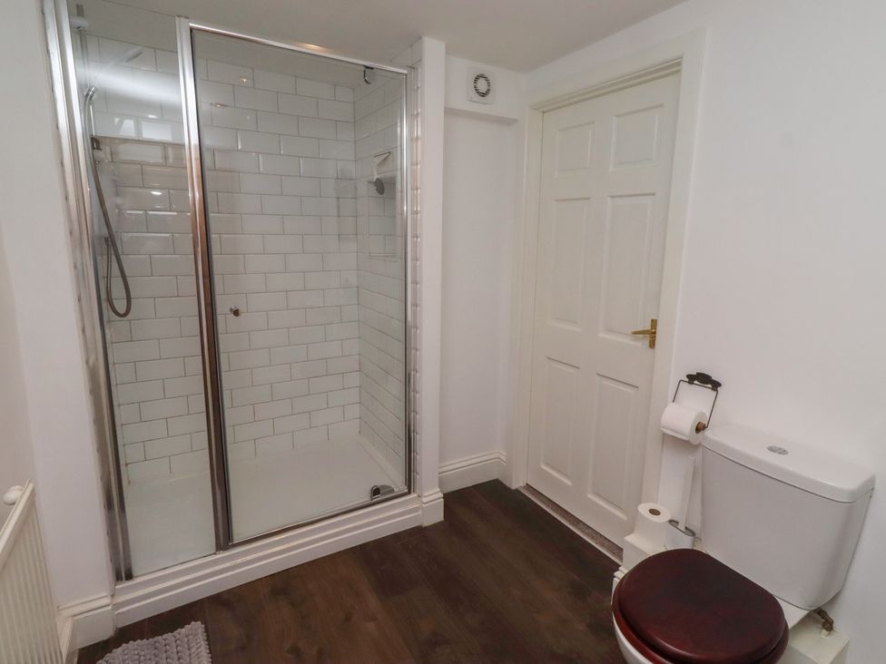 A bathroom with a shower and toilet at The Coach House Crookham near Cornhill-On-Tweed
