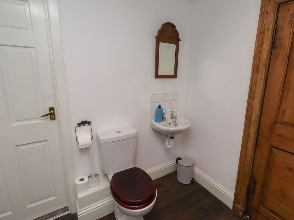 A bathroom with a toilet and sink at The Coach House in Crookham near Cornhill-On-Tweed