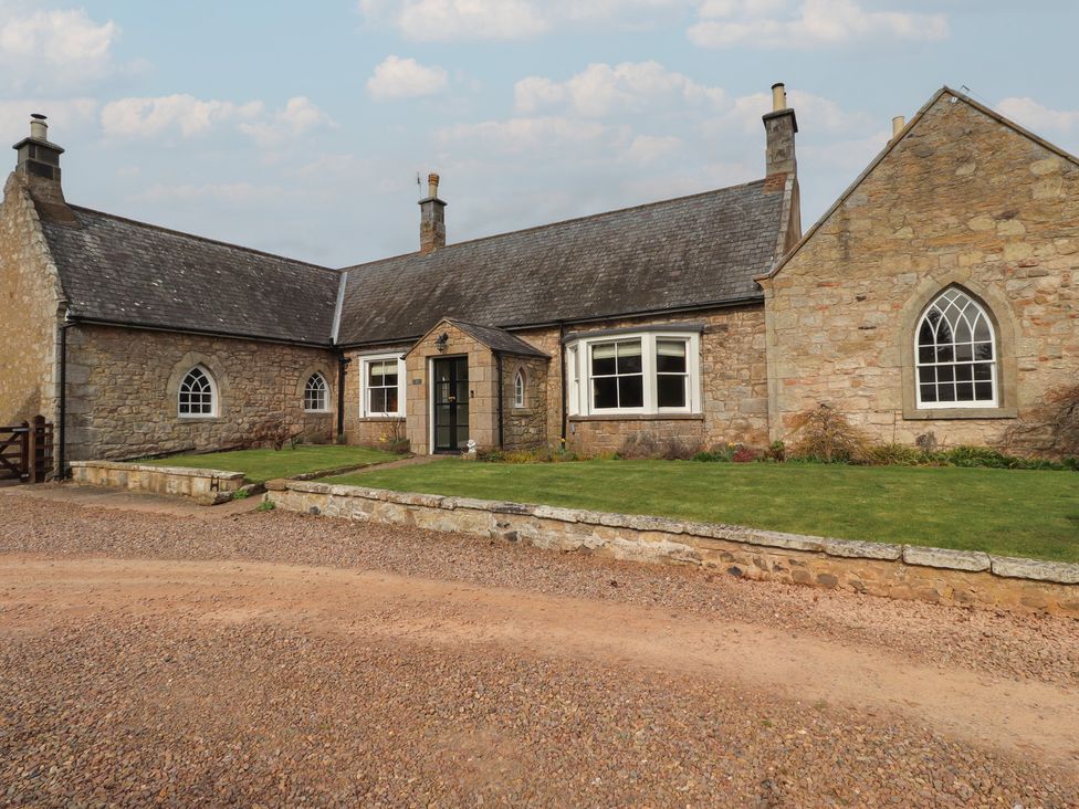 A house with a garden and pathway at The Coach House in Crookham near Cornhill-On-Tweed