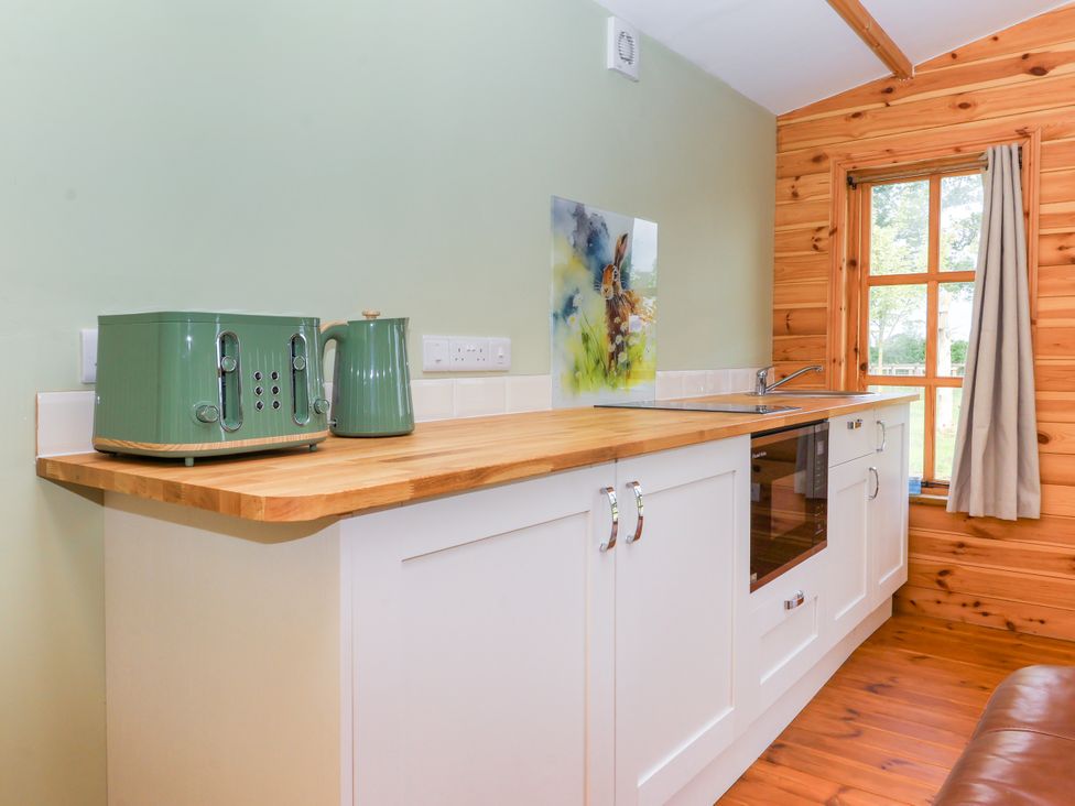 A kitchen with a toaster and kettle on a countertop at Lodge 1 York