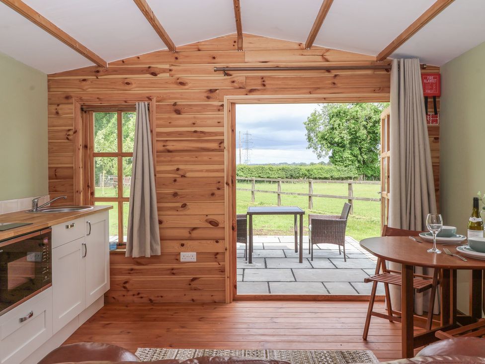 A kitchen with a view of the outdoor patio at Lodge 1 in Strensall