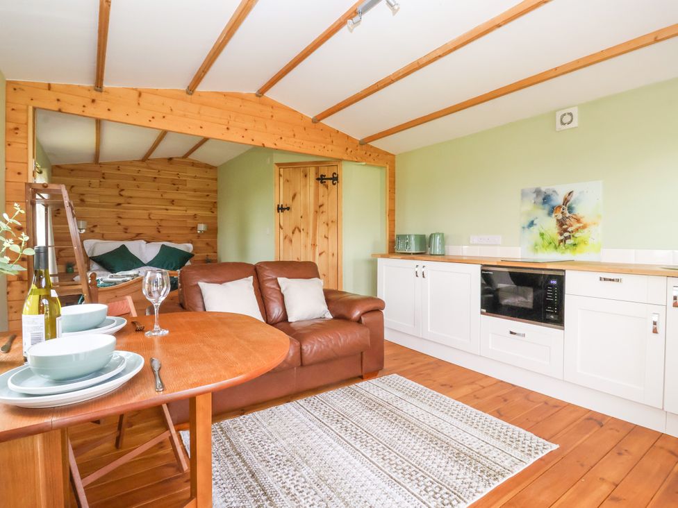 A living room with a couch and table at Lodge 2 in York