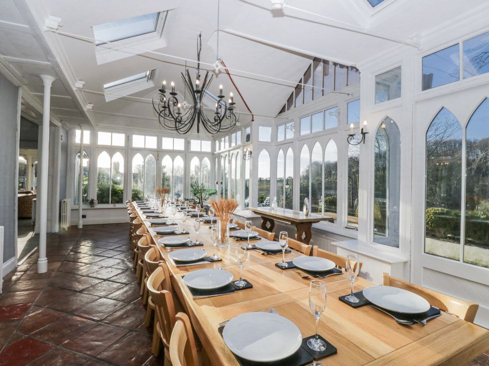 A dining room with a long table set for a meal at Valley View in Dalton-In-Furness