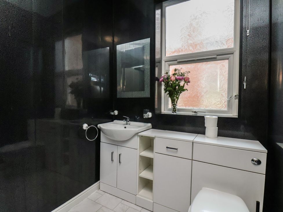 A bathroom with a sink and mirror at Bridlington Bay House in Bridlington