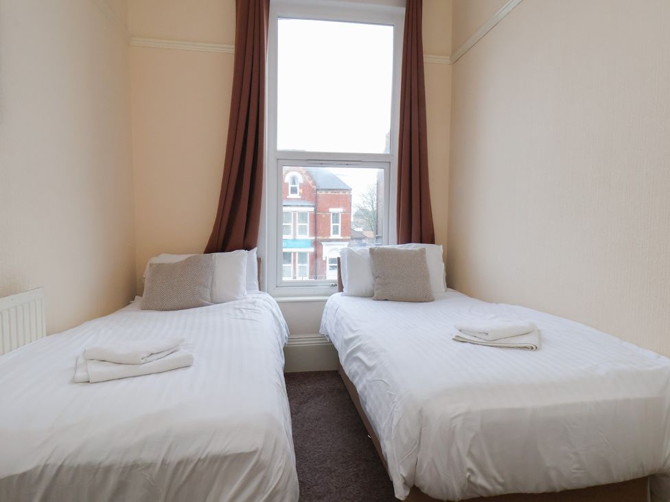A bedroom with two beds and a window at Bridlington Bay House in Bridlington