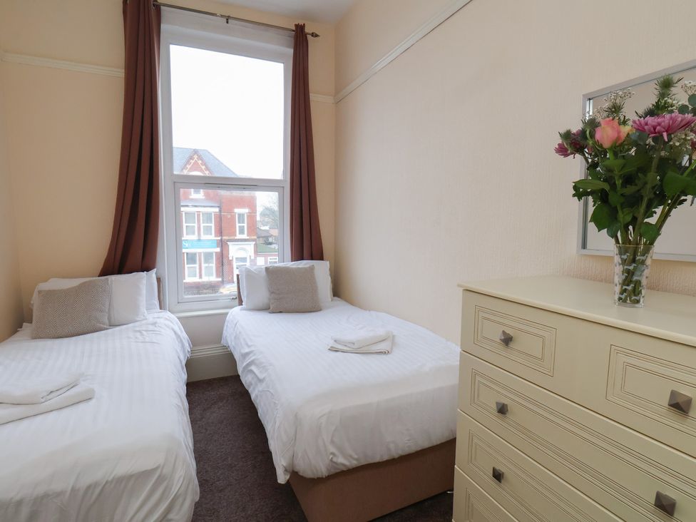 A bedroom with two beds and a dresser at Bridlington Bay House in Bridlington