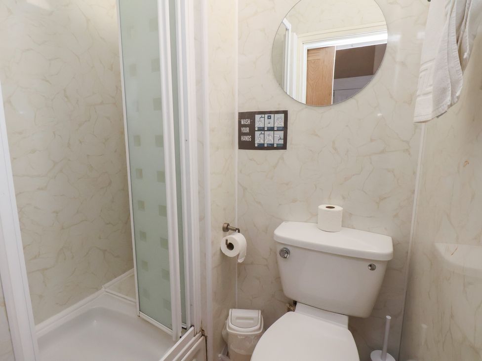 A bathroom with a toilet and shower at Bridlington Bay House in Bridlington