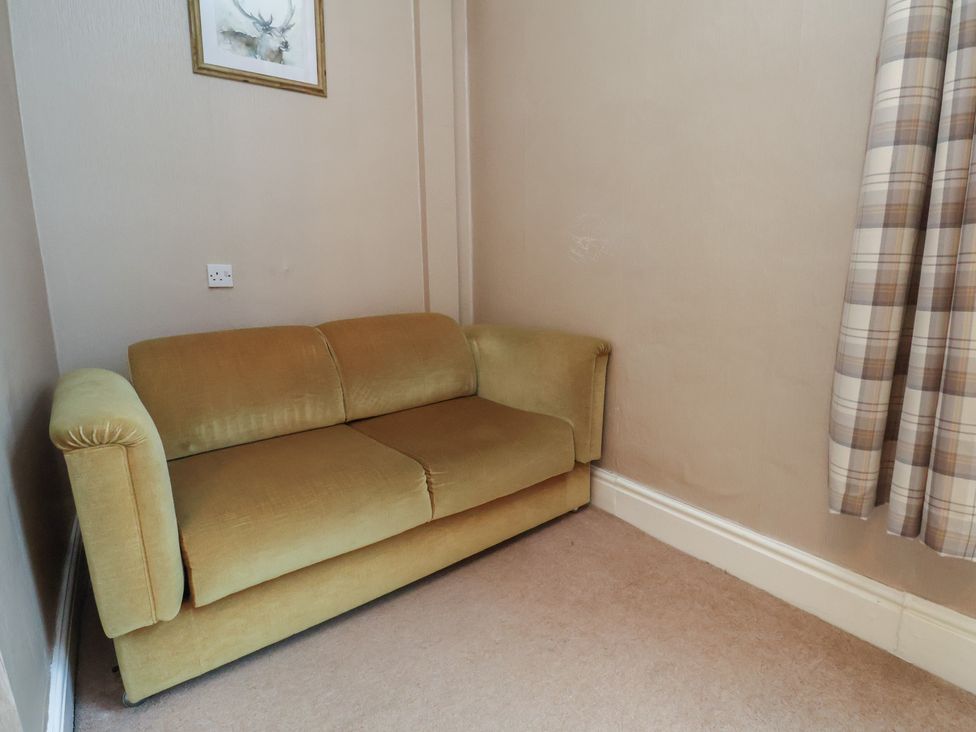 A living room with a sofa and curtains at Bridlington Bay House in Bridlington