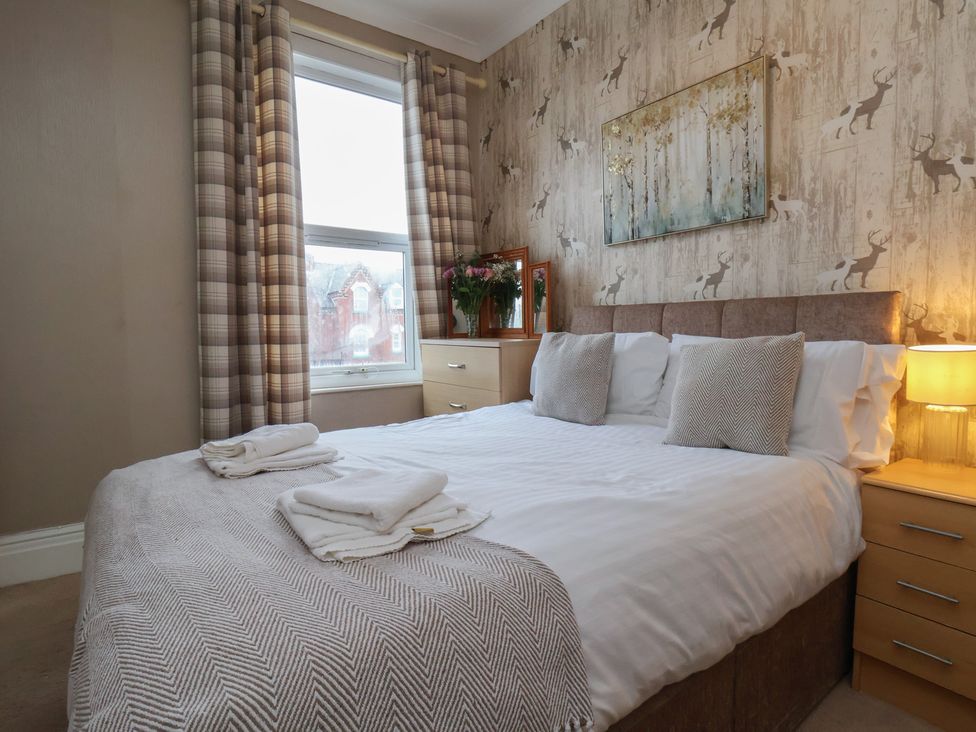 A bedroom with a bed and a dresser at Bridlington Bay House in Bridlington