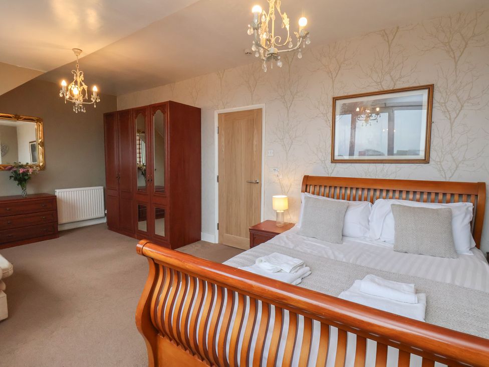 A bedroom with a bed and dresser at Bridlington Bay House in Bridlington