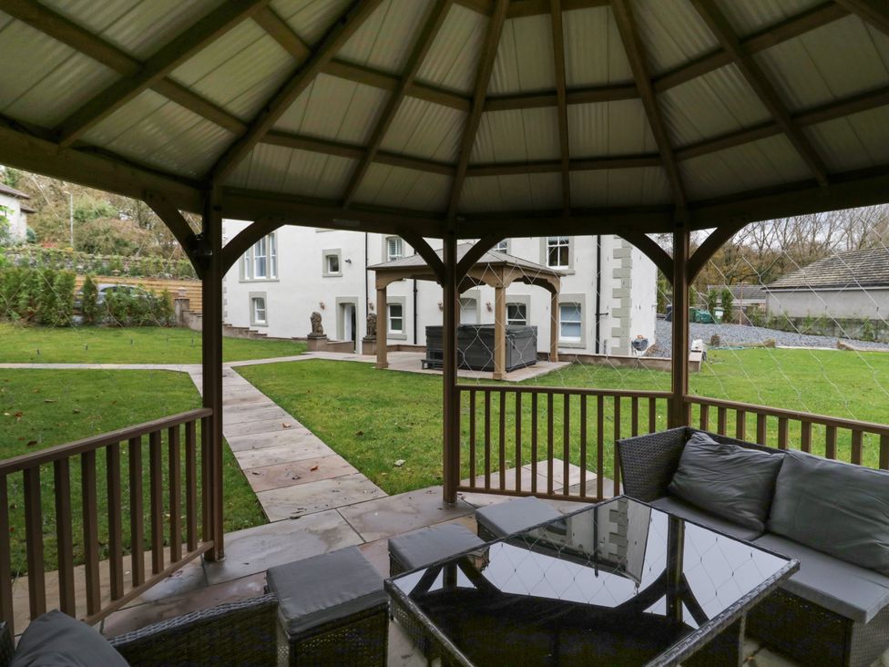 A garden with a gazebo and seating area at Beechgrove Manor in Workington