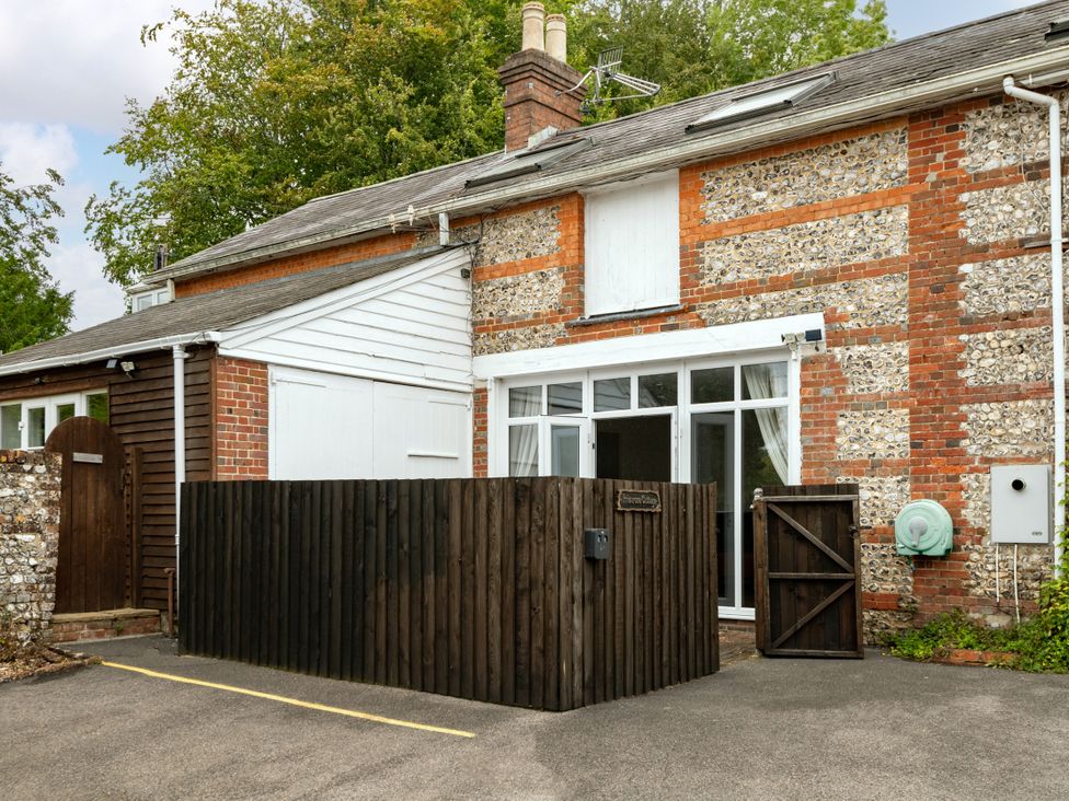 An outdoor view of a building with windows and a fence at Primrose in Blandford Forum
