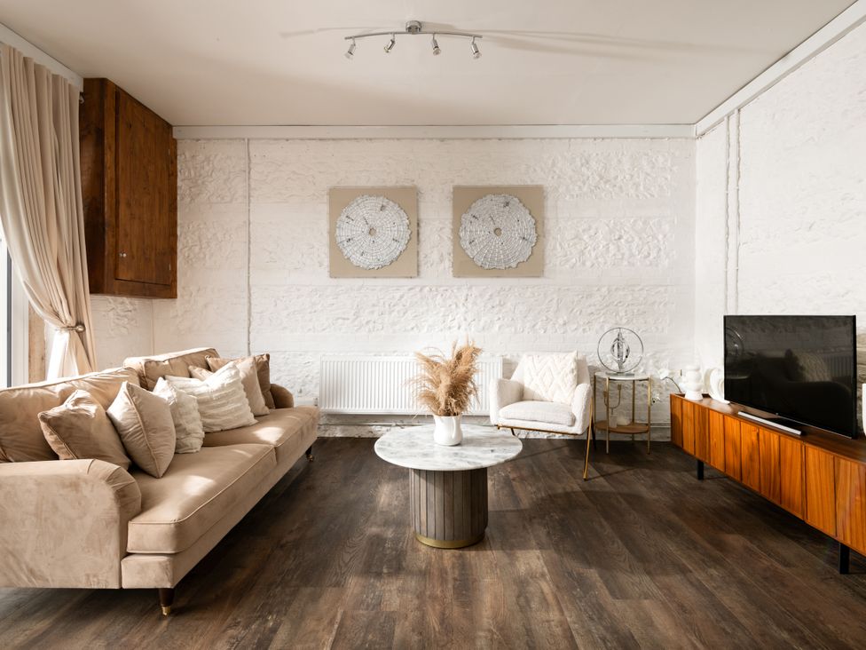 A living room with a sofa and coffee table at Primrose in Blandford Forum