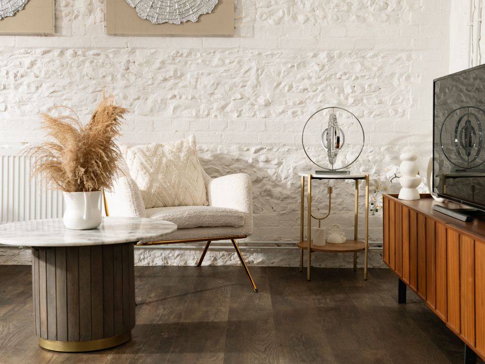 A living room with a sofa and coffee table at Primrose in Blandford Forum