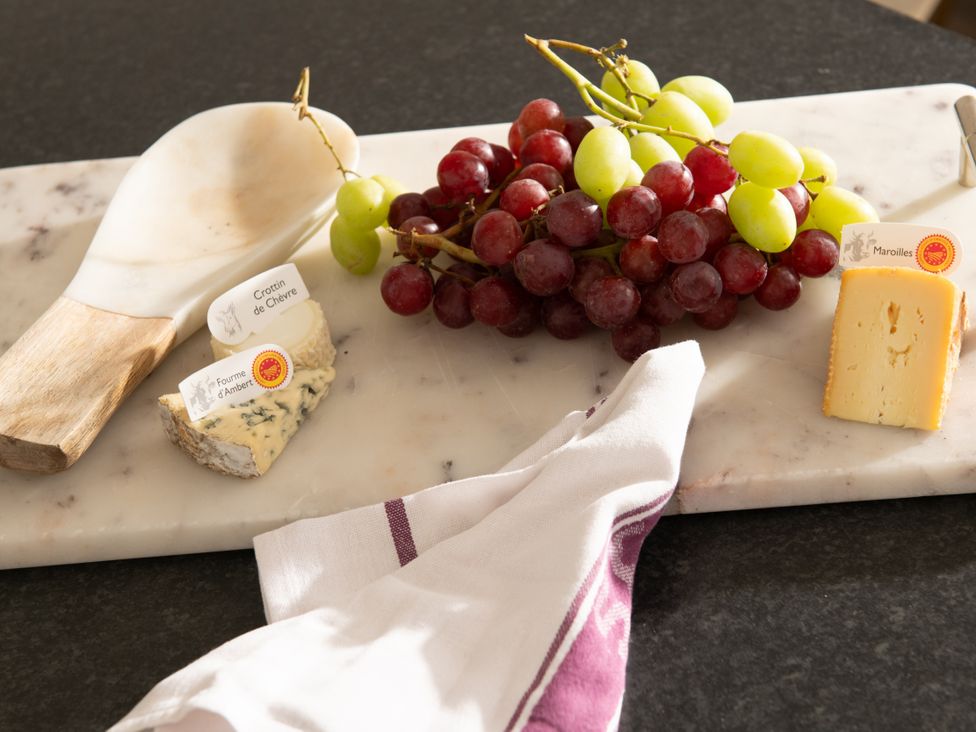 A cheese board with assorted cheeses and grapes at Primrose in Blandford Forum