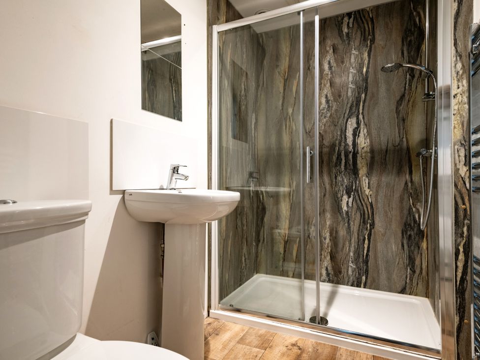 A bathroom with a toilet, sink, and shower at Primrose in Blandford Forum