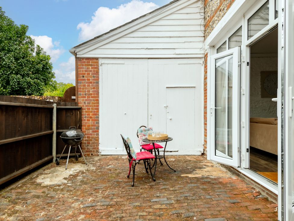 An outdoor area with a table and chairs at Primrose in Blandford Forum
