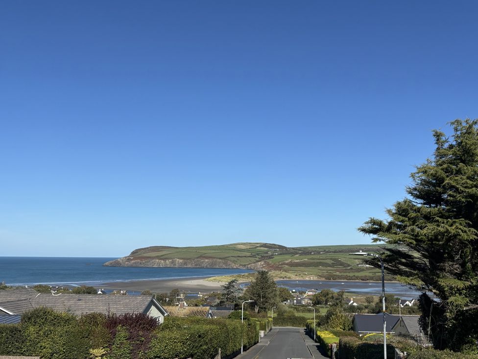 A view of the ocean and houses from a hill at Bryn Alaw in Newport, Pembrokeshire