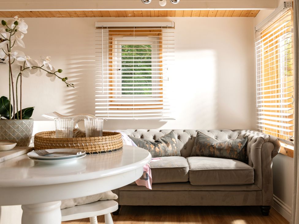 A living room with a sofa and table at Hazel in Blandford Forum