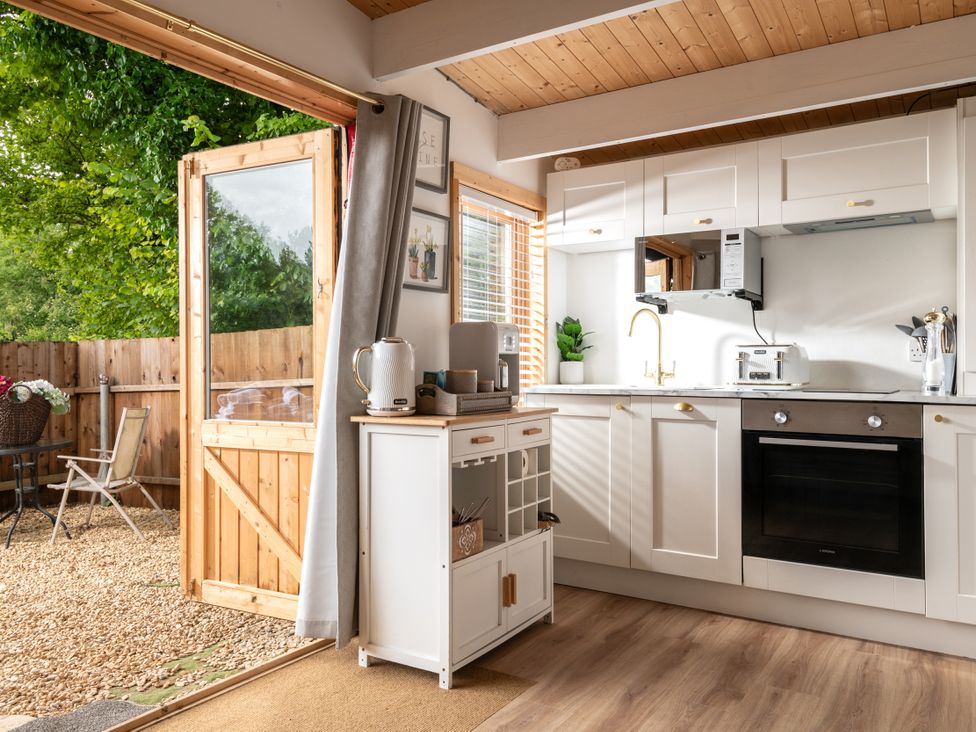 A kitchen with a door leading outside at Hazel in Blandford Forum