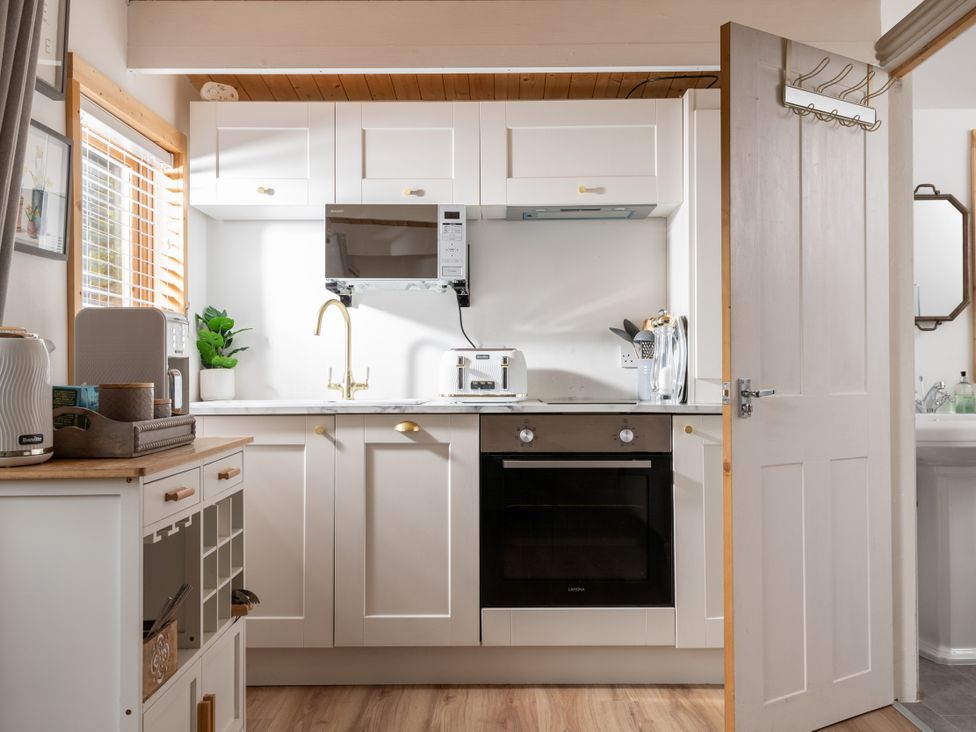 A kitchen with cabinets and appliances at Hazel in Blandford Forum