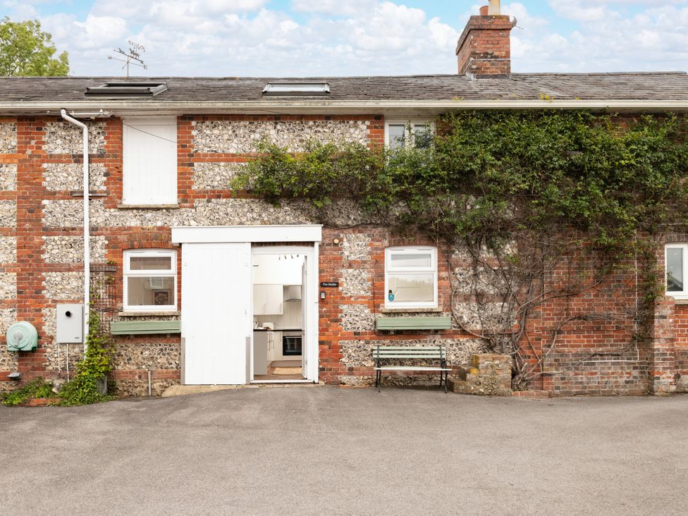 An exterior view of a building with a door leading to a kitchen at Stable in Blandford Forum