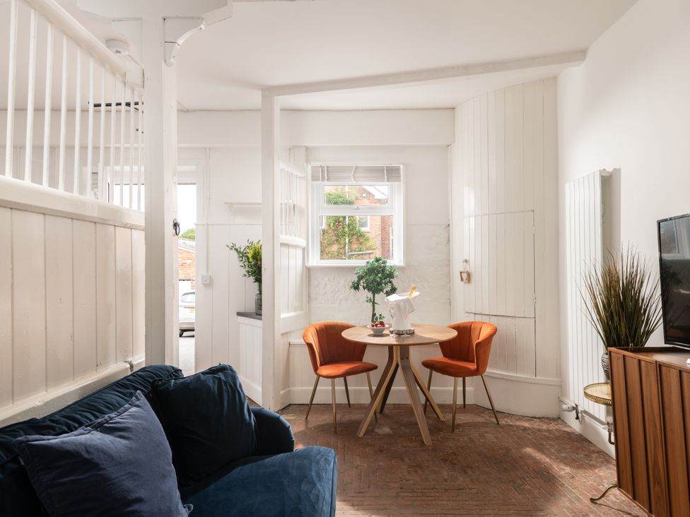 A living room with a table and chairs at Stable in Blandford Forum