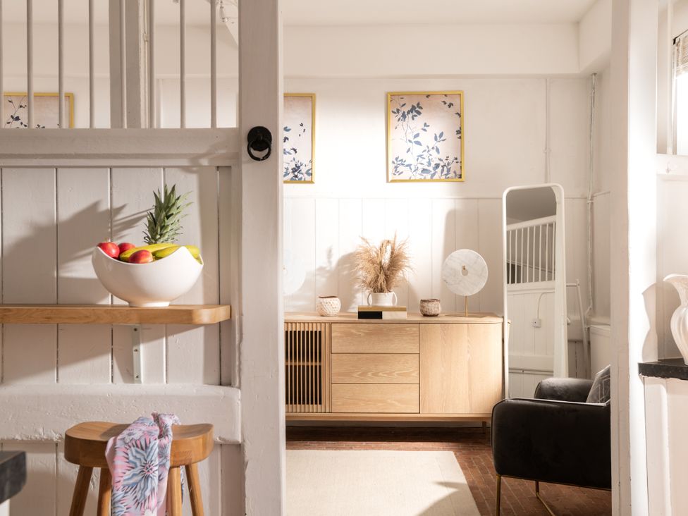 A living room with a sideboard and fruit bowl at Stable in Blandford Forum
