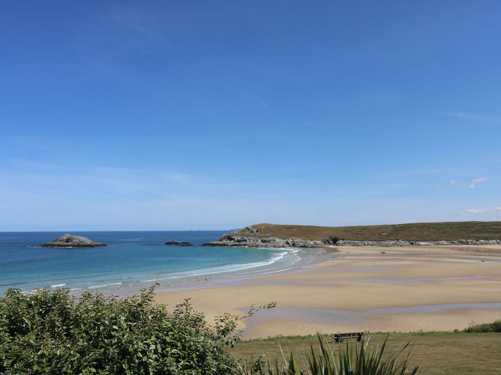 A beach scene with sea and sand under a clear sky at Newquay Tamarisk Lodge on the Gannel, Newquay