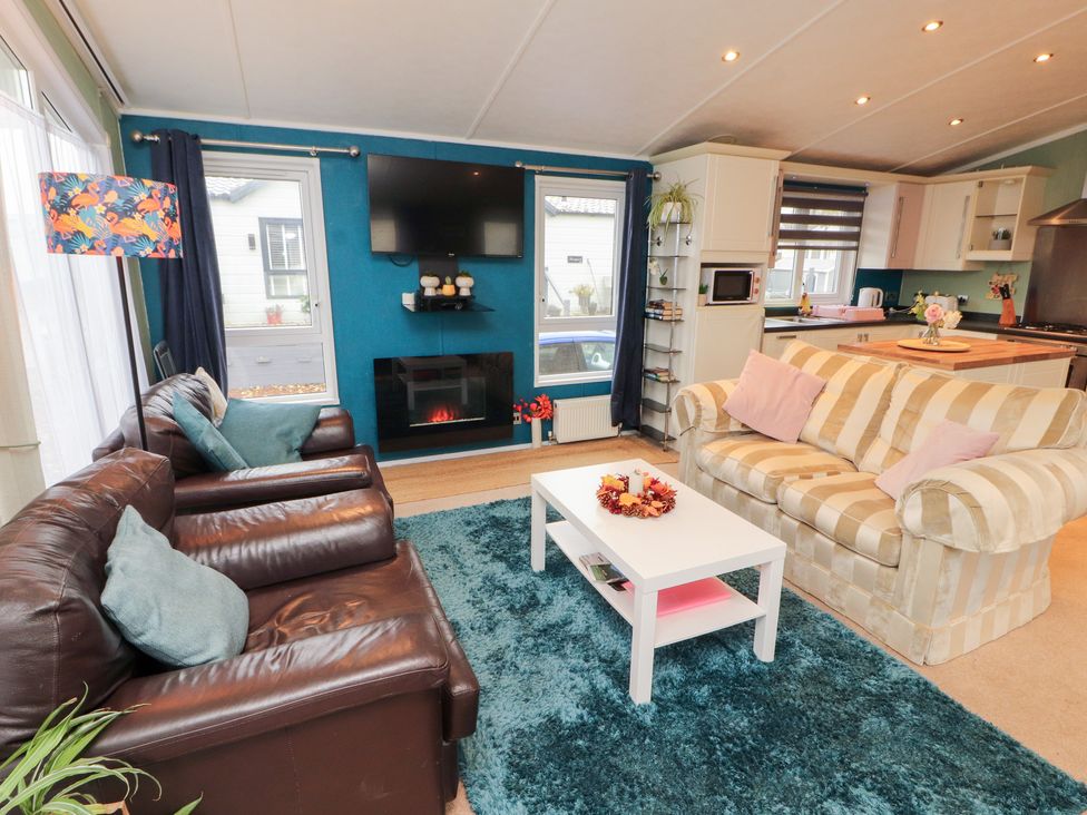 A living room with sofas and a television at Rosie's Zen Den High Hesket near Armathwaite