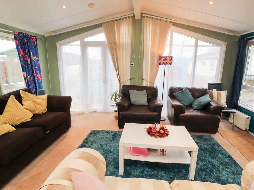 A snug with seating and a coffee table at Rosie's Zen Den in High Hesket near Armathwaite