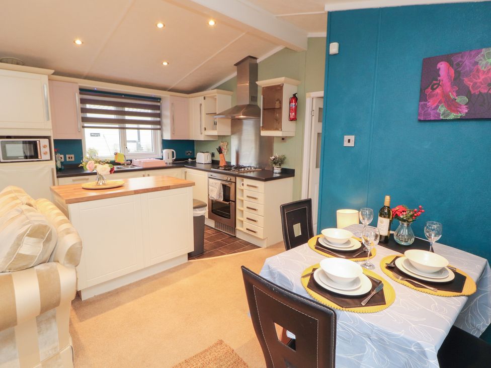 A kitchen with a dining table set at Rosie's Zen Den in High Hesket near Armathwaite