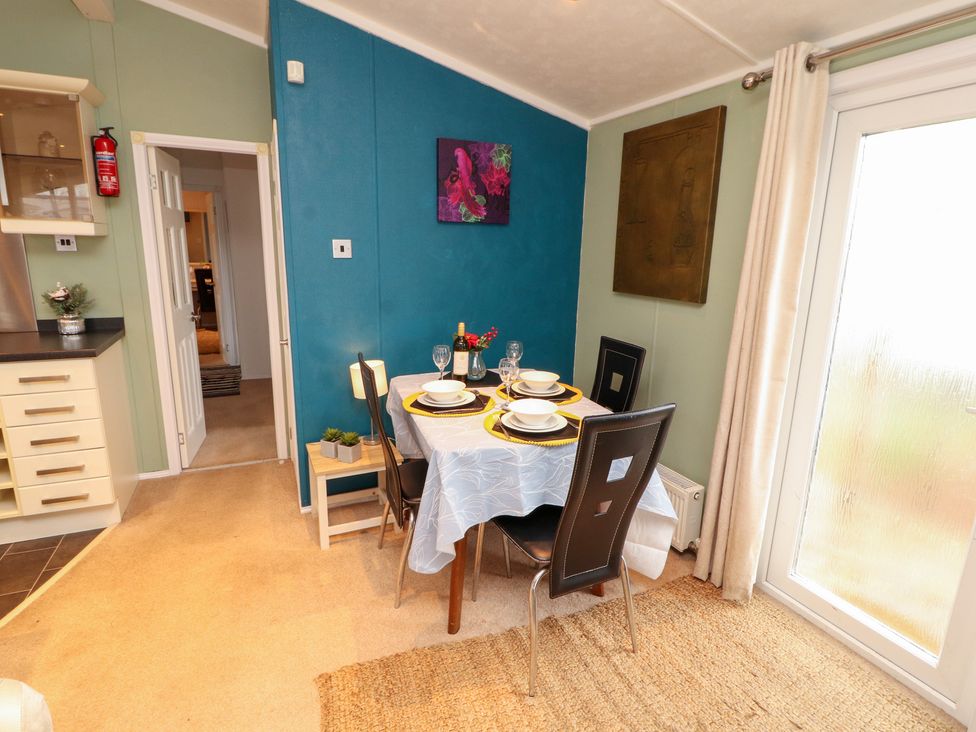 A dining room with a table and chairs at Rosie's Zen Den High Hesket near Armathwaite