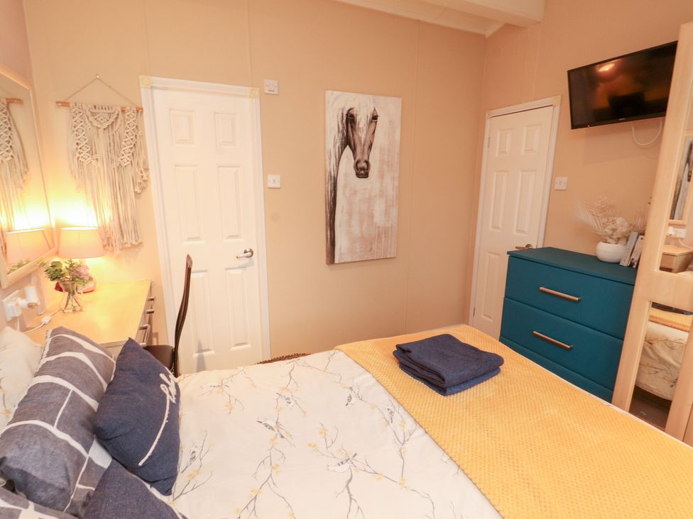 A bedroom with bed and dresser at Rosie's Zen Den High Hesket near Armathwaite