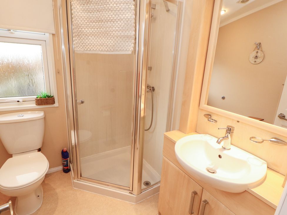 A bathroom with a shower, toilet, and sink at Rosie's Zen Den in High Hesket near Armathwaite