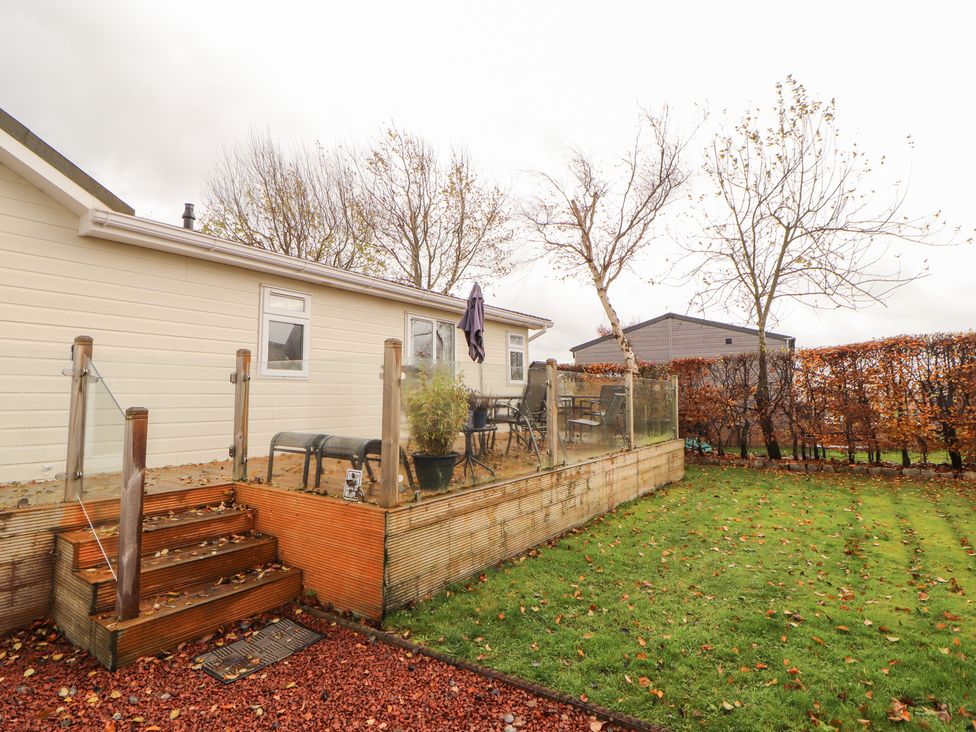 A garden with steps and seating area at Rosie's Zen Den in High Hesket near Armathwaite
