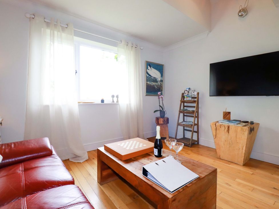 A living room with a sofa and coffee table at Sea View in St Austell