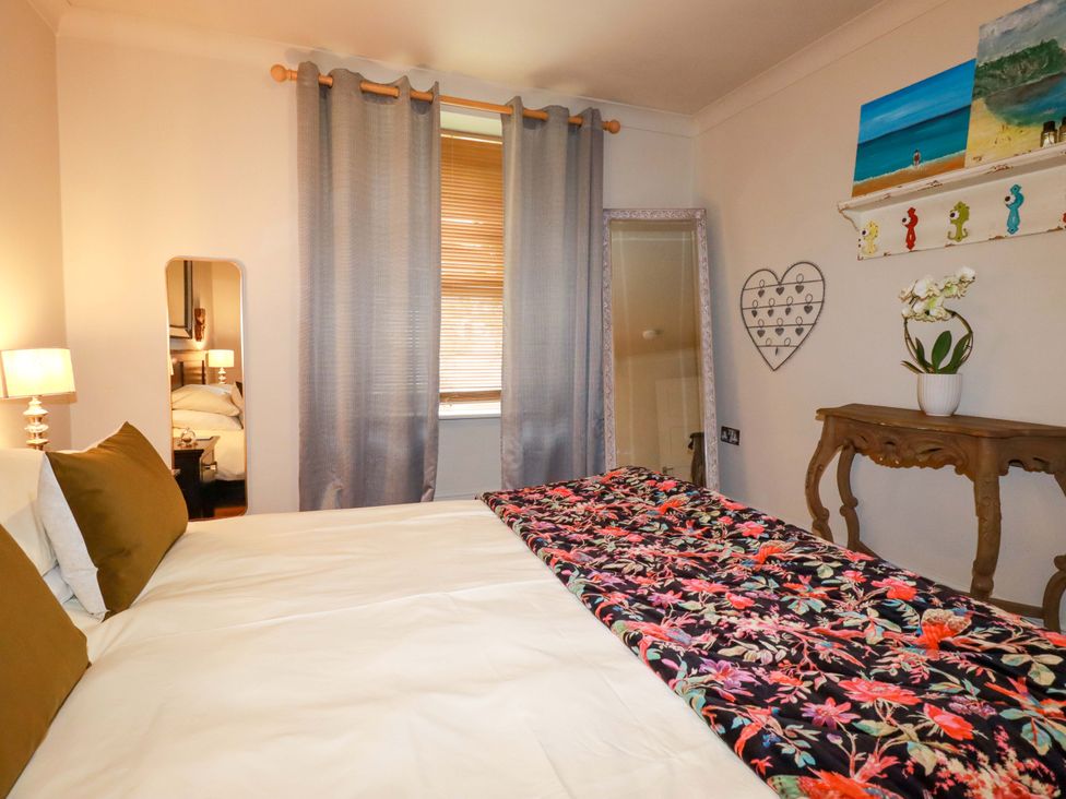 A bedroom with a bed and decorative elements at Sea View in St Austell