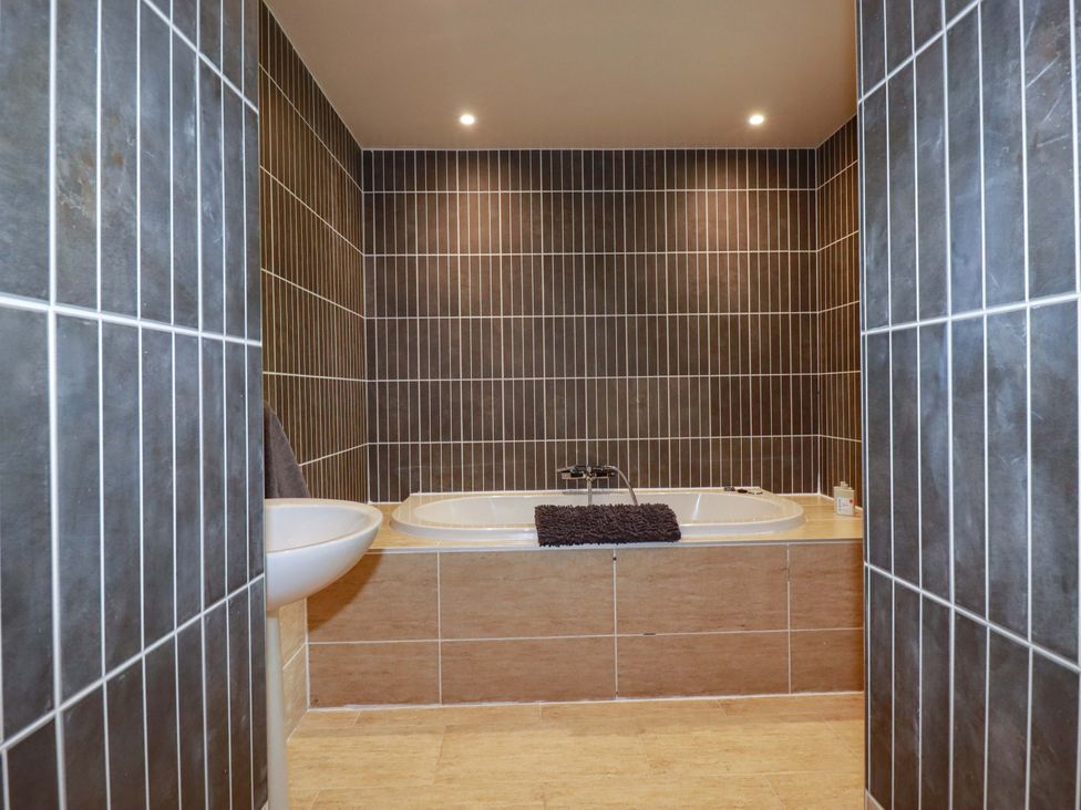 A bathroom with a bathtub and sink at Sea View in St Austell