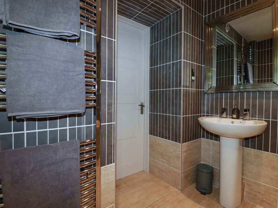 A bathroom with a sink and towel warmer at Sea View in St Austell