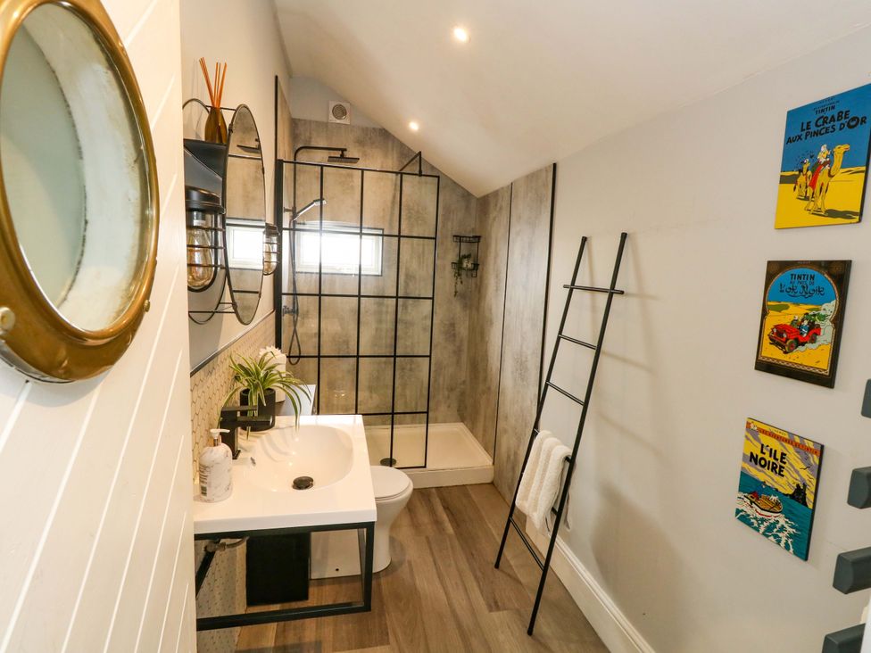 A bathroom featuring a shower, sink, and toilet at The Old Post Office in Weymouth