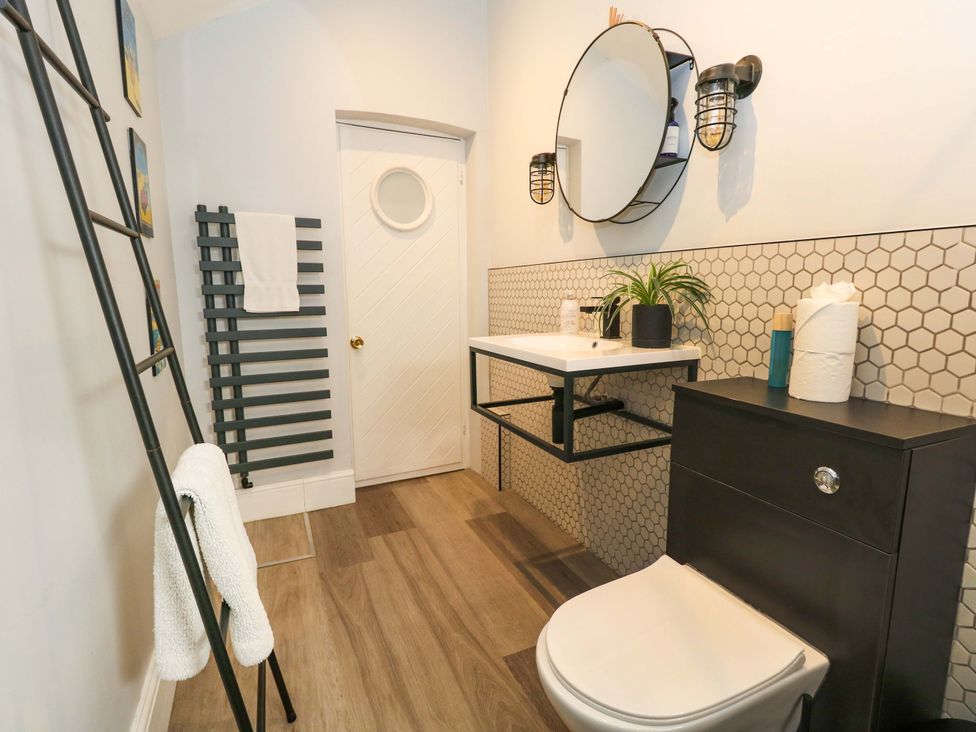 A bathroom with a sink and toilet at The Old Post Office in Weymouth