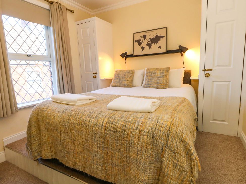 A bedroom with a bed and map at The Old Post Office in Weymouth