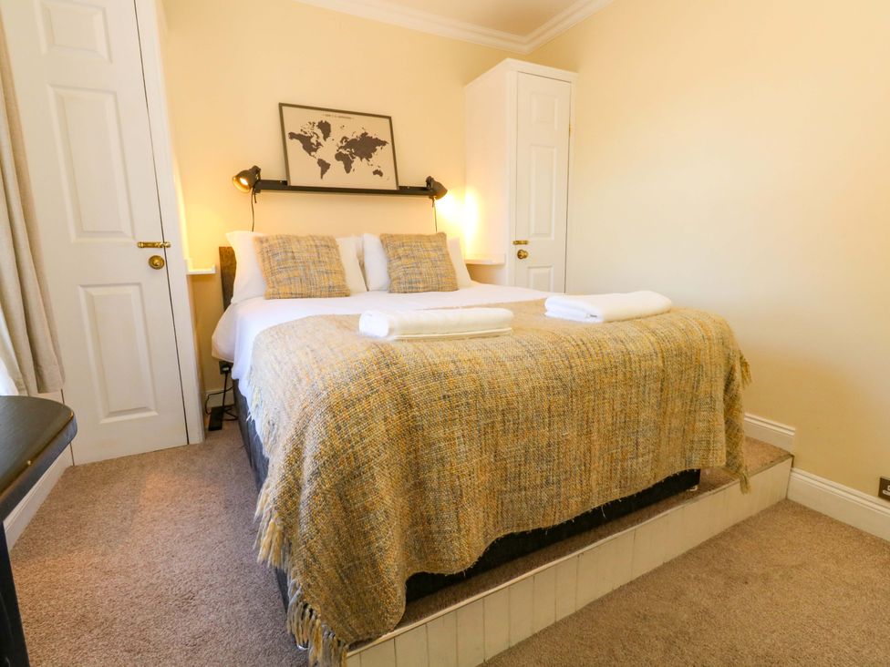 A bedroom with a bed and map on the wall at The Old Post Office in Weymouth