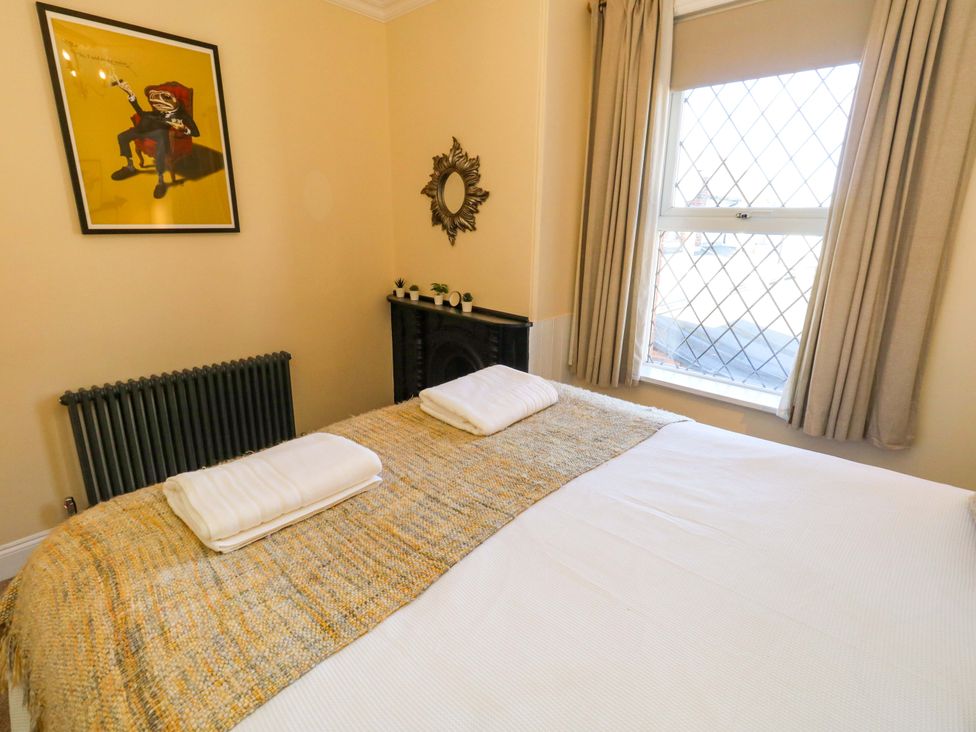 A bedroom with a bed and a window at The Old Post Office in Weymouth
